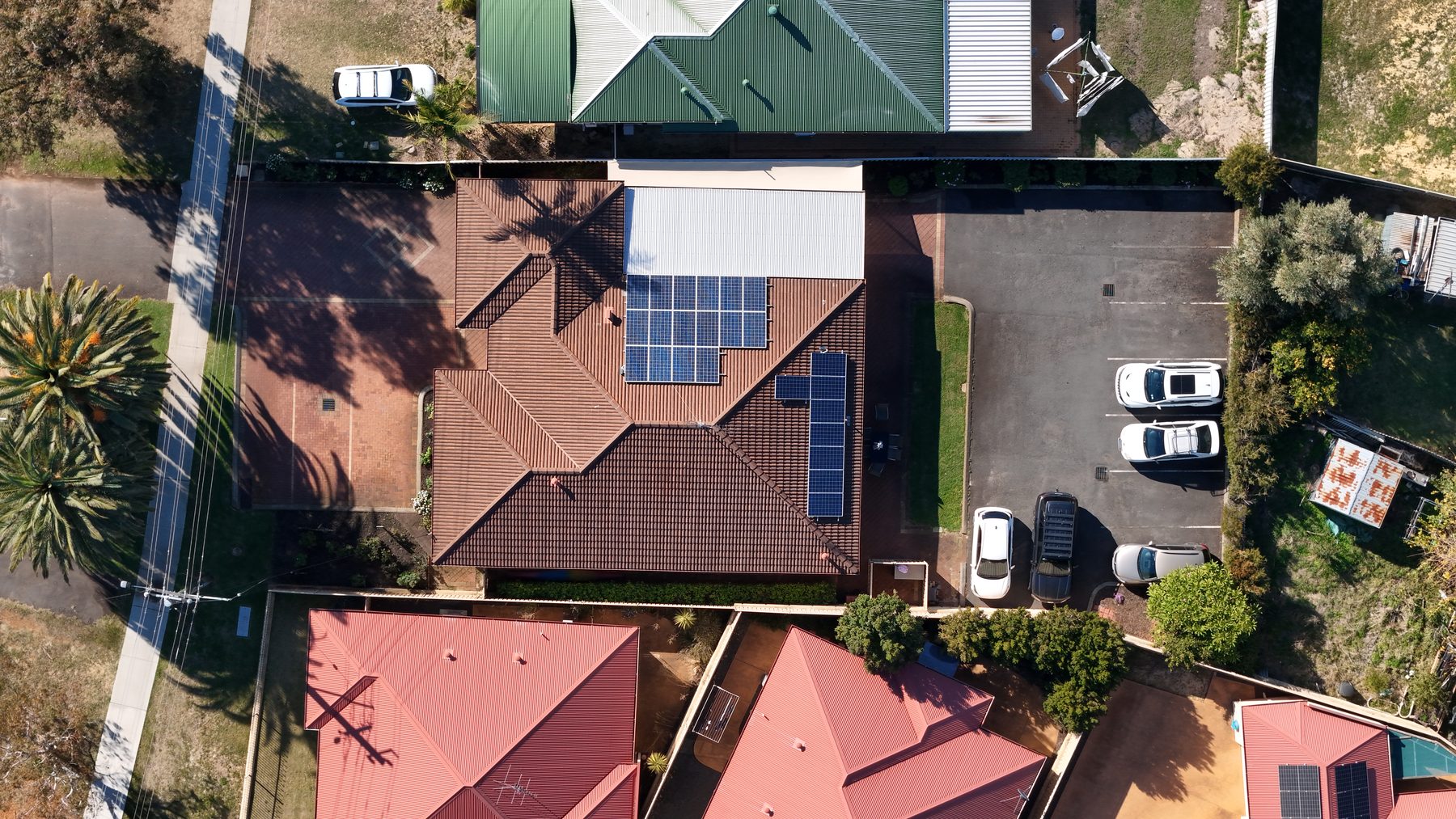 Aerial view of Australind Dental Centre on Old Coast Road, showing the on-site car park at the rear of the practice with marked bays and driveway access