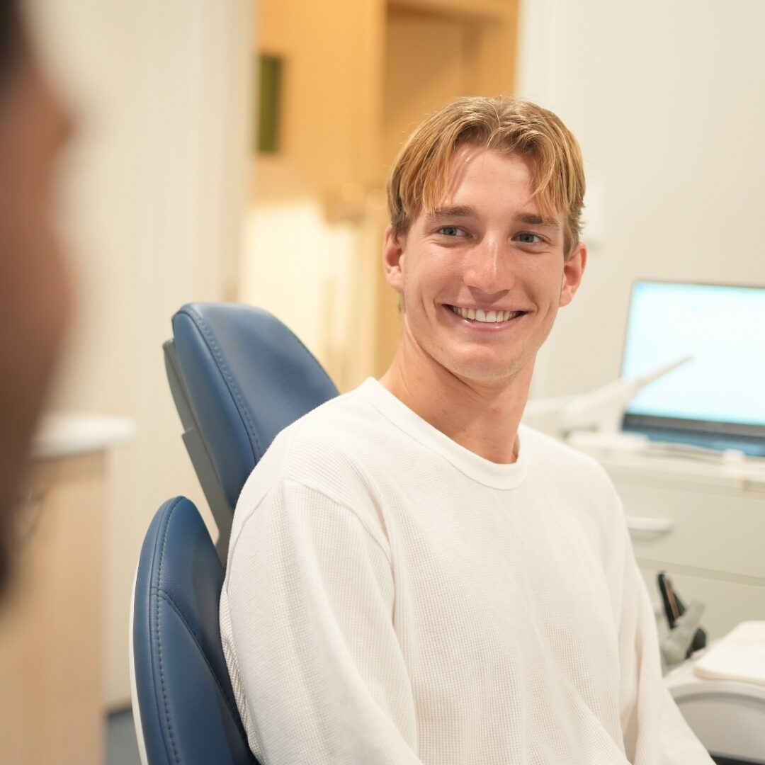 A patient smiling in a modern treatment chair at Australind Dental Centre