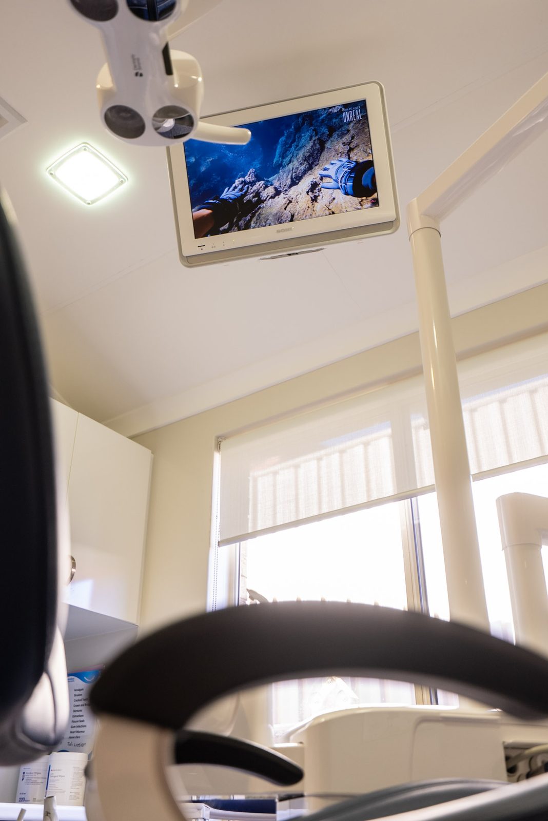 Ceiling-mounted television above the dental chair in a surgery room at Australind Dental Centre